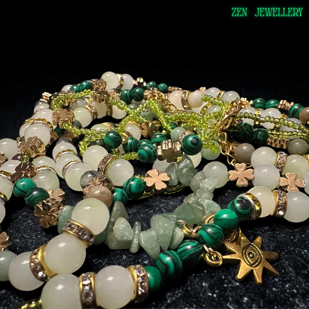 • Celestial inspired gemstone jewellery set with layered necklace strands in soft green, cream, and earthy brown tones accented by gold spacer beads and sparkling crystal details. The combination of aventurine gemstones, floral charms, and yin yang pendant symbols creates meaningful spiritual jewellery with elegant feminine style and handcrafted artistic texture.