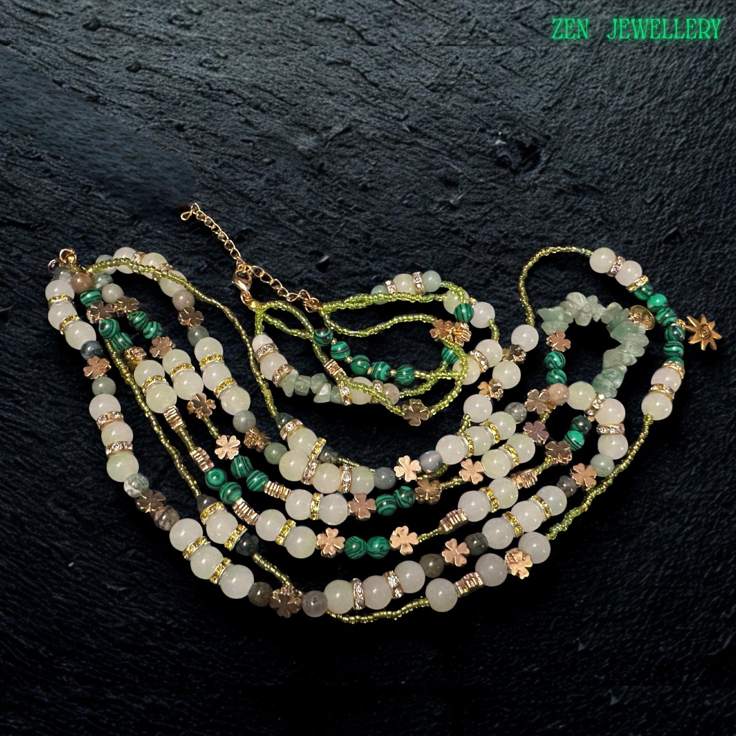 • Beautiful close up image of the double strand bracelet included in the jewellery set, featuring polished aventurine beads, green crystal accents, floral spacer charms, rhinestone rings, and adjustable gold clasp details. The layered bracelet complements the necklace perfectly and creates an elegant handcrafted bohemian jewellery look with natural earthy sophistication.