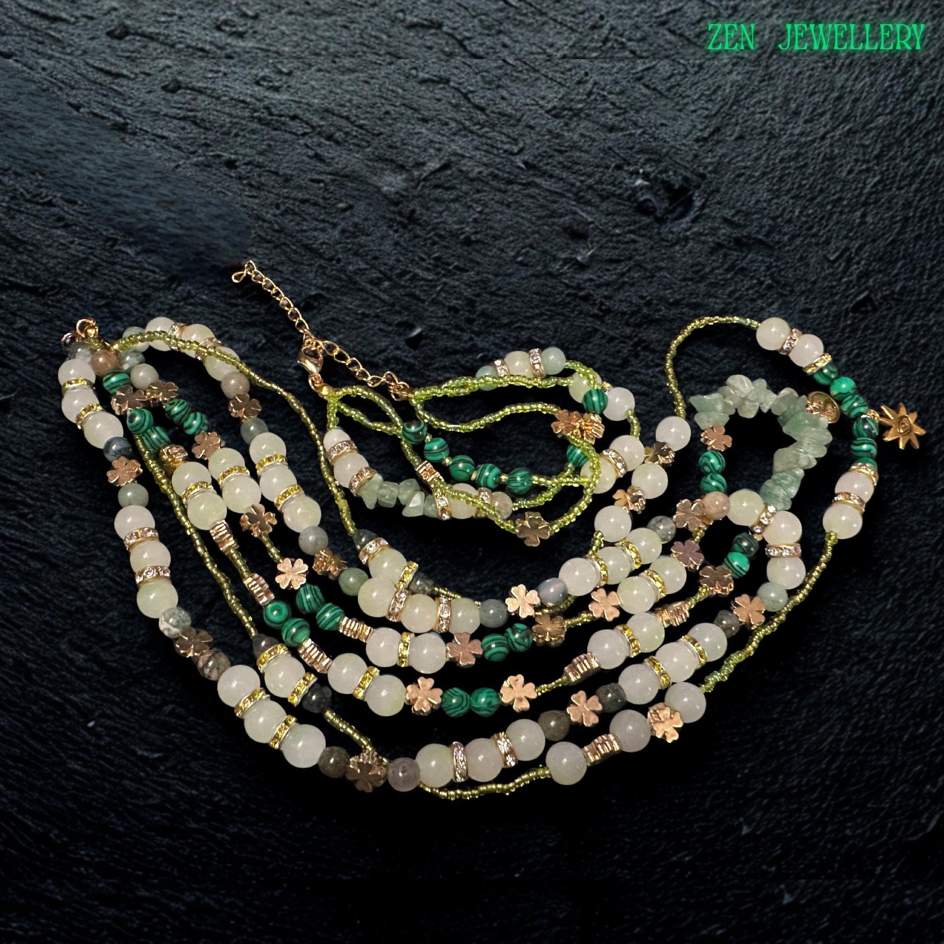 • Beautiful close up image of the double strand bracelet included in the jewellery set, featuring polished aventurine beads, green crystal accents, floral spacer charms, rhinestone rings, and adjustable gold clasp details. The layered bracelet complements the necklace perfectly and creates an elegant handcrafted bohemian jewellery look with natural earthy sophistication.