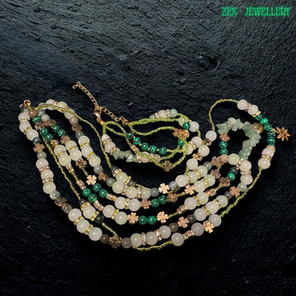 • Beautiful close up image of the double strand bracelet included in the jewellery set, featuring polished aventurine beads, green crystal accents, floral spacer charms, rhinestone rings, and adjustable gold clasp details. The layered bracelet complements the necklace perfectly and creates an elegant handcrafted bohemian jewellery look with natural earthy sophistication.