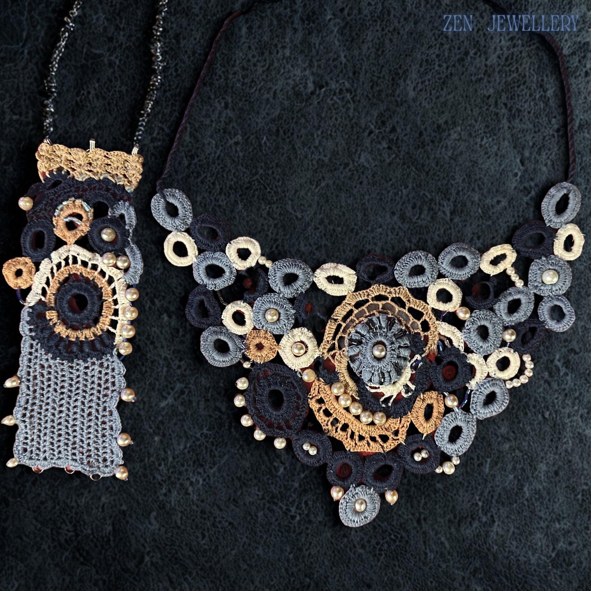Handcrafted textile necklace featuring pearl decorated crochet motifs arranged in an asymmetrical floral-inspired composition with dimensional layered embroidery, soft cotton textures and romantic boho luxury aesthetics designed to complement elegant evening outfits and bridal looks.