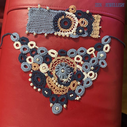 Close detail image of handmade pearl crochet jewellery showing the precision stitching, layered circular embroidery and subtle shine of the pearl accents integrated throughout the necklace, creating an artistic couture-inspired accessory with a soft, feminine appearance and luxury artisan craftsmanship.