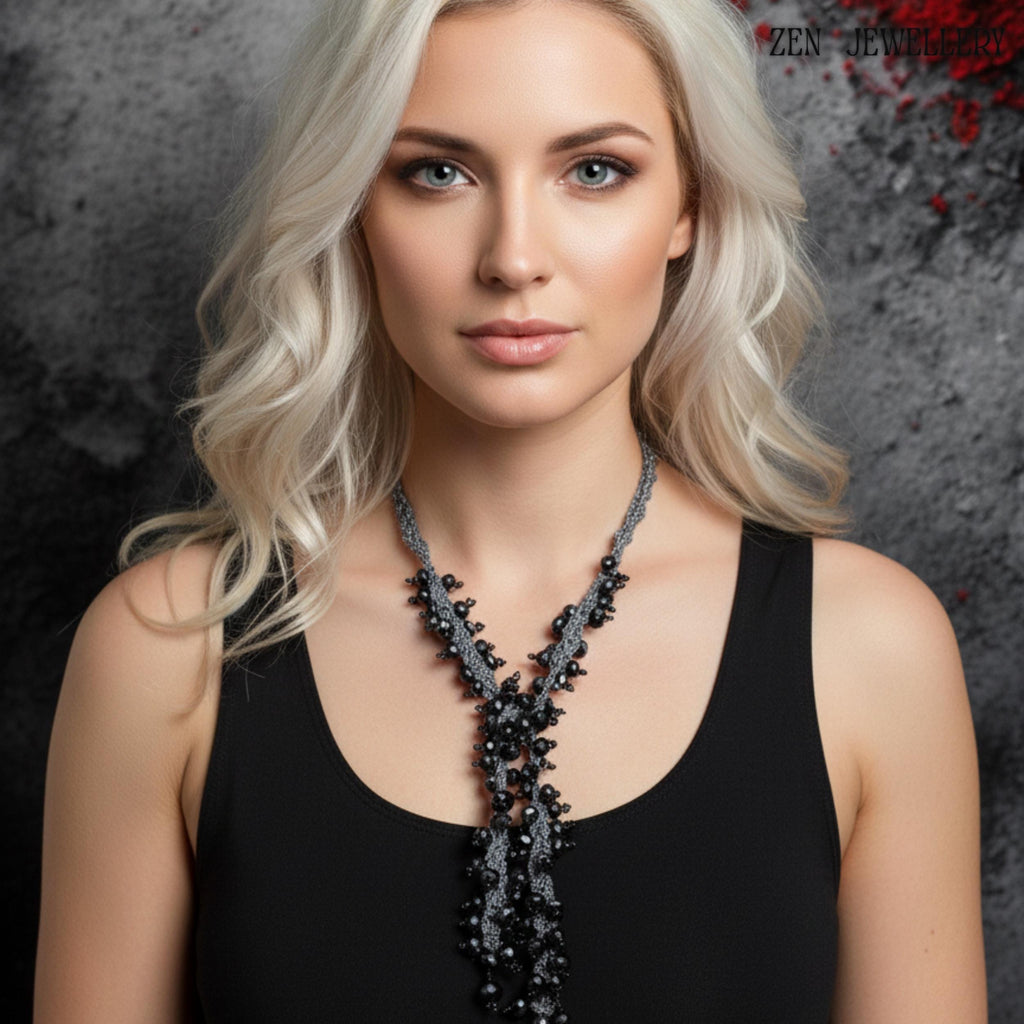 Artisan black crystal necklace and bracelet set made with charcoal silk crochet and sterling silver clasps, designed in a bold chunky statement style. The image focuses on the craftsmanship details, including tightly crocheted silk patterns and carefully spaced crystal clusters. The faceted beads shimmer subtly under light, giving the jewellery an elegant, glamorous appearance suitable for parties, evening occasions, or artistic fashion styling.