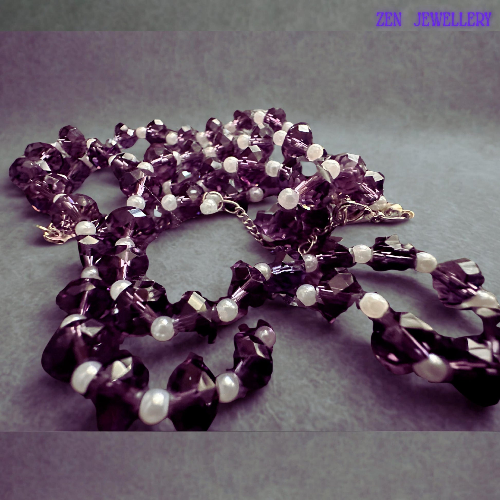 Sparkling purple crystal jewellery set designed with reflective faceted glass beads and delicate white pearl accents creating an elegant lightweight necklace and bracelet set for special occasions and gifting.