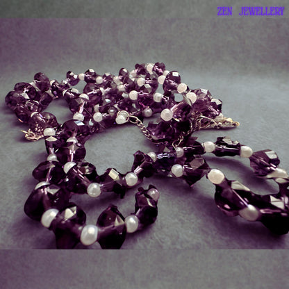 Sparkling purple crystal jewellery set designed with reflective faceted glass beads and delicate white pearl accents creating an elegant lightweight necklace and bracelet set for special occasions and gifting.