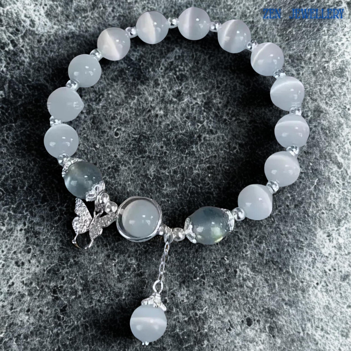 Bracelet shown against textured stone surface providing scale and context, allowing buyers to appreciate the proportions of the gemstone beads, decorative silver accents and dangling charm elements while highlighting the elegant arrangement and handcrafted quality that contribute to its timeless and versatile jewellery appeal.