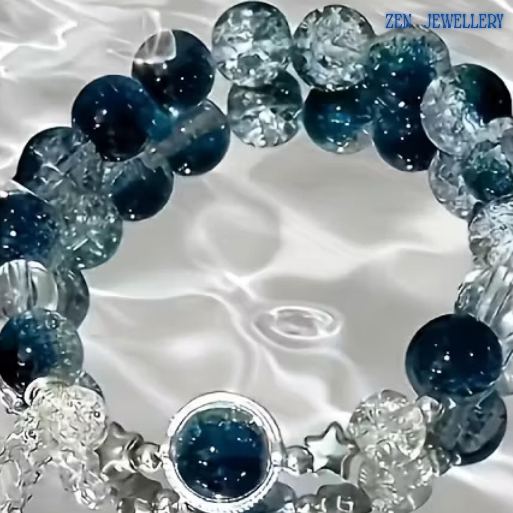 Full bracelet image displayed against a bright reflective background that resembles rippling water. The ocean-inspired setting enhances the deep blue gemstones and crystal accents, helping buyers visualise the tranquil and elegant aesthetic of the bracelet. The adjustable design measures 19 cm (7.48 inches) for versatile wear.