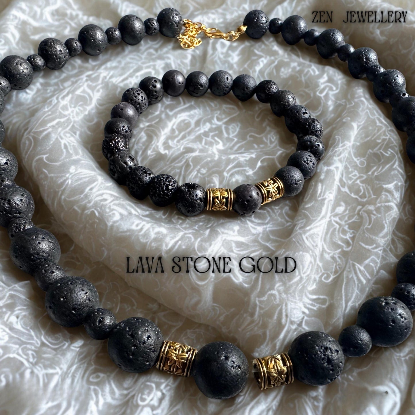 Elegant close-up of the necklace clasp and golden extension chain, highlighting the refined handmade details of the volcanic bead jewellery set. The natural lava stones feature a porous matte surface with organic texture variations that make each piece unique. The combination of black volcanic beads and warm gold accents creates a balanced, minimalist bohemian style.
