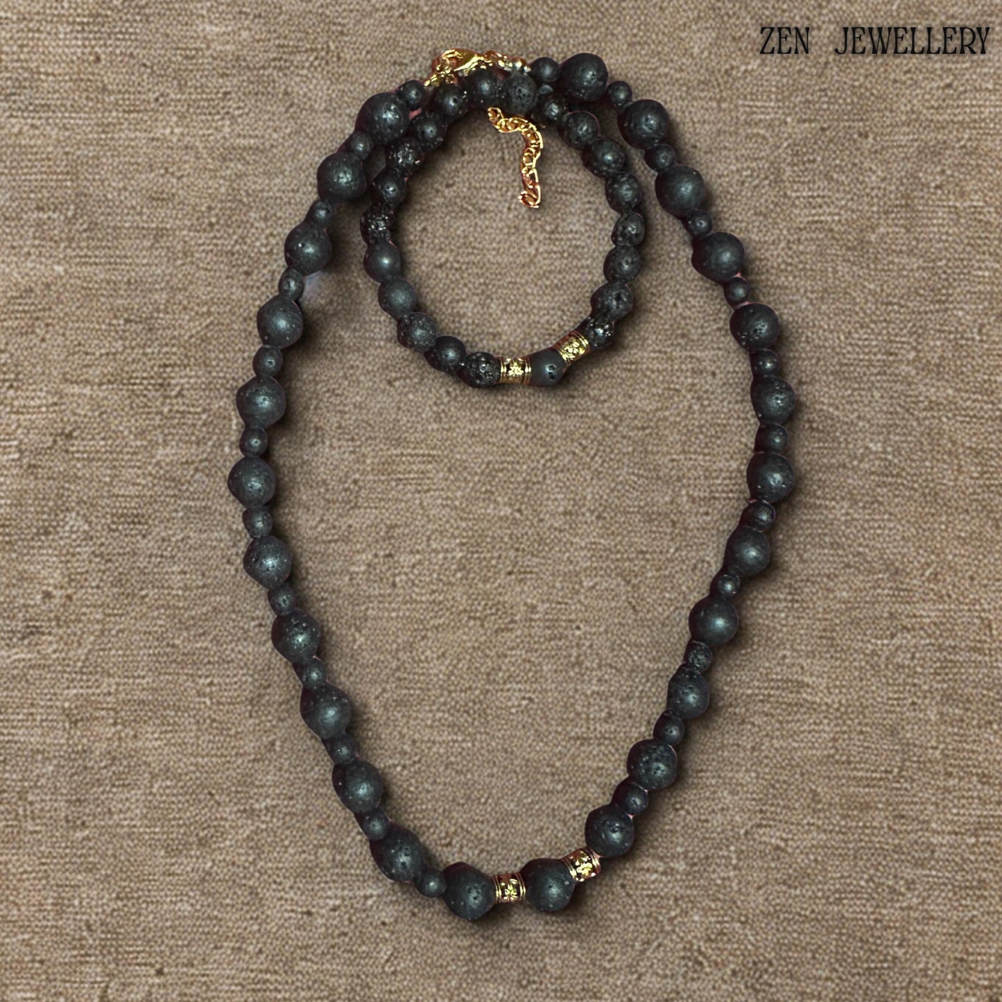 Handmade black lava stone jewellery set with textured volcanic beads, golden artisan spacers, and a warm earthy minimalist aesthetic. The necklace and bracelet feature carefully balanced bead sizes and elegant gold-tone closures that create a timeless handcrafted appearance inspired by natural volcanic materials and modern bohemian fashion.
