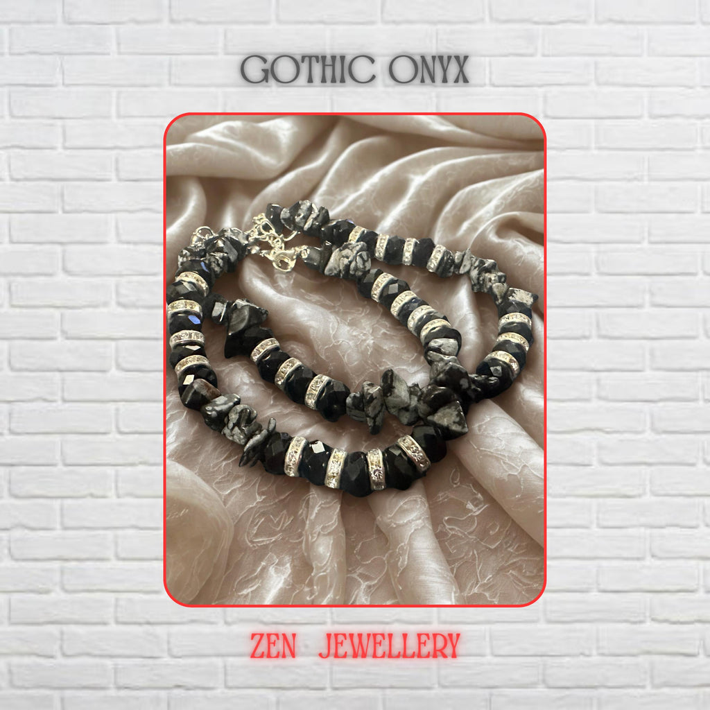 Close-up view highlighting the faceted black crystal beads with their glossy reflective surfaces. Sparkling rhinestone spacer beads catch the light between each crystal, creating a glamorous contrast against the deep black tones. Natural grey gemstone chips add texture and organic beauty throughout the layered bracelet design.