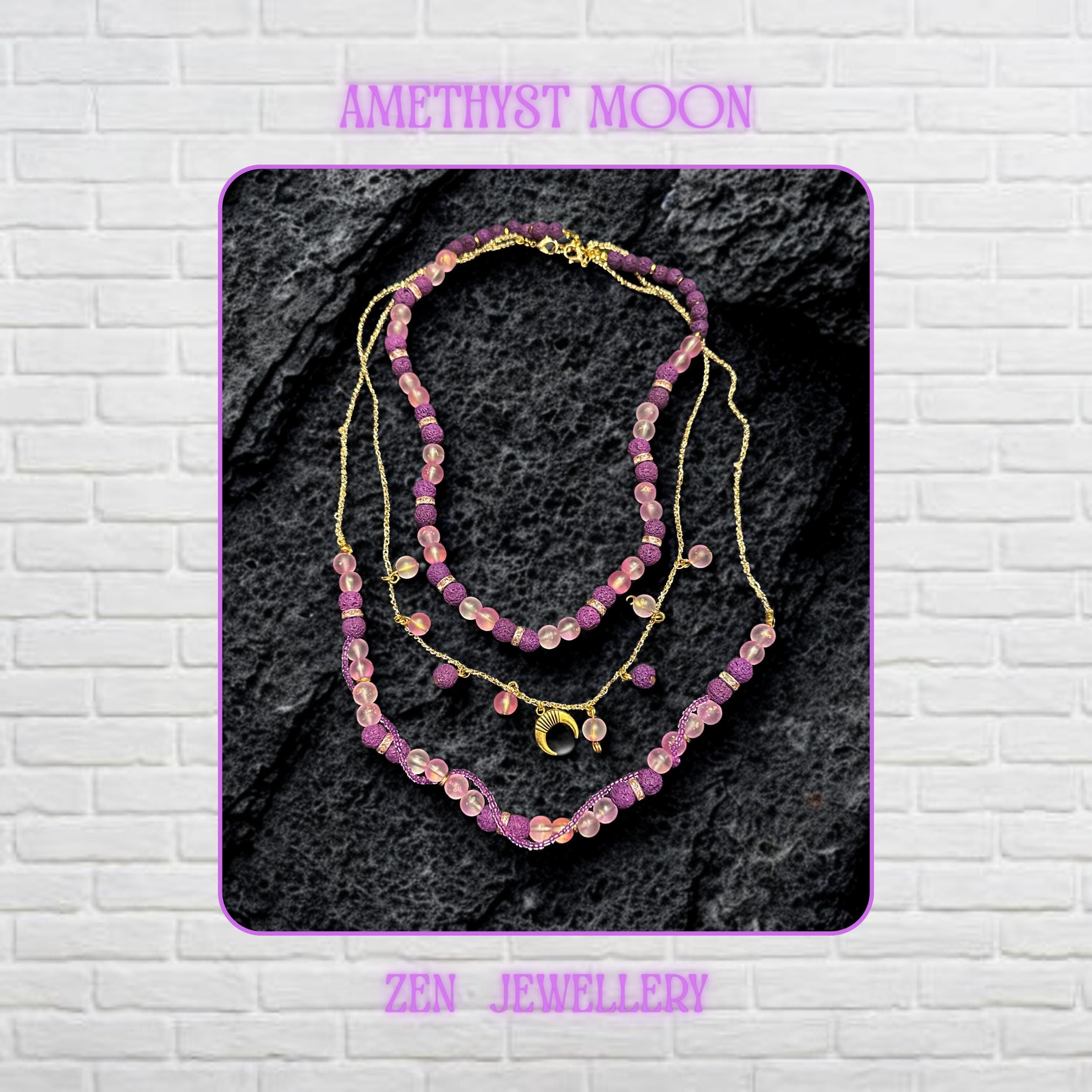 • Close-up view of the layered necklace showing polished translucent pink gemstone beads with a soft frosted glow contrasted against textured volcanic purple lava stone beads. Gold spacer rings with rhinestone sparkle separate the beads beautifully while the delicate gold chain drapes naturally across the dark decorative surface. The crescent moon charm becomes the focal point and adds mystical celestial elegance to the handmade artistic jeweller