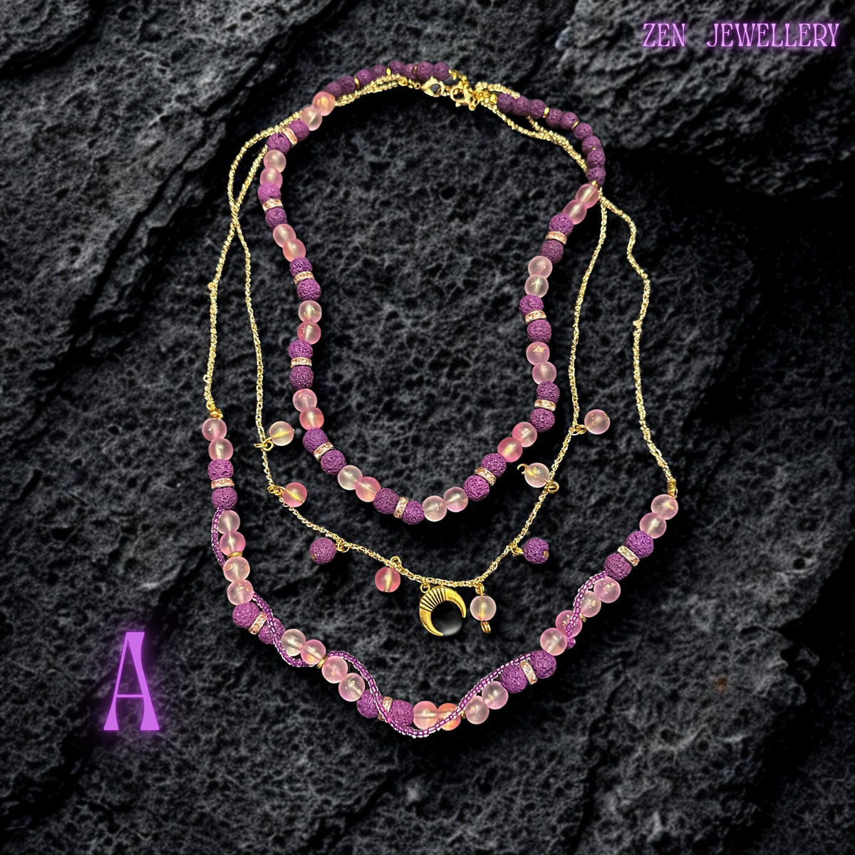 Lava stone necklace with pink glass beads and purple textured stones on gold chain
Close-up of purple lava stone beads with porous texture and matte finish
Pink translucent glass beads reflecting light softly along necklace