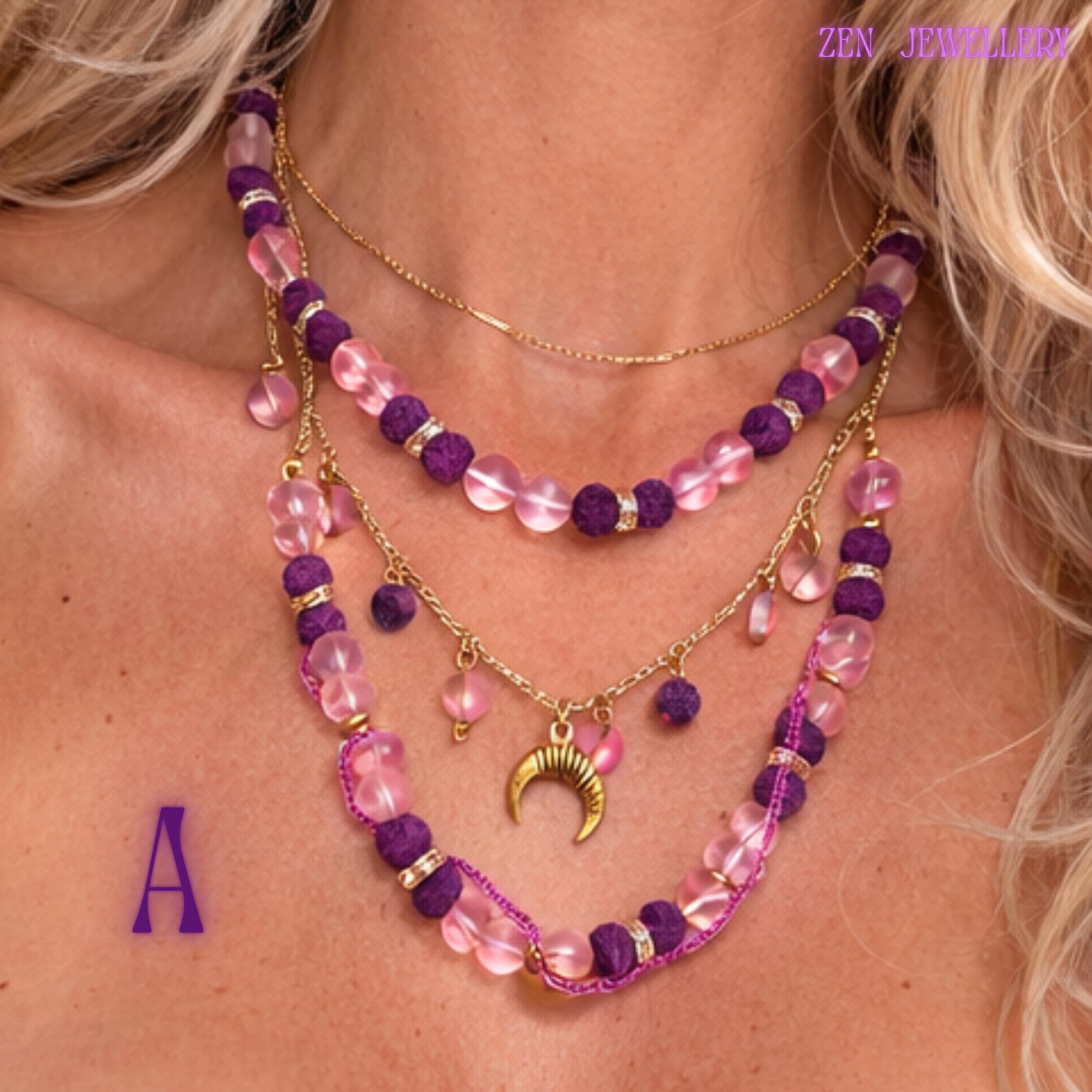 • Detailed product image focusing on the celestial crescent moon pendant attached to a delicate gold chain surrounded by small floating blush pink gemstone charms. The polished gold crescent contrasts beautifully with the soft pink and purple tones while adding mystical symbolism and feminine energy to the handcrafted layered gemstone jewellery set inspired by celestial and spiritual fashion.