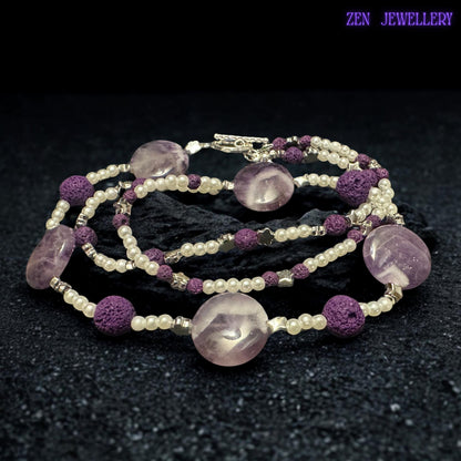 The silver toggle clasp and dangling bead details give this handmade purple necklace a unique artisan finish. The textured lava stone beads add depth and contrast while the glossy crystal-style beads create soft sparkle and luxurious movement.