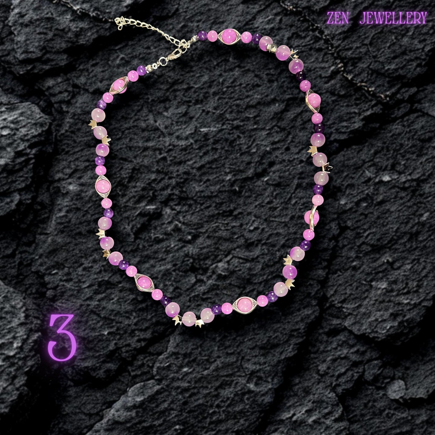 • Romantic layered necklace made from chunky silver chains and polished pastel gemstone beads in soft pink, lilac, and purple tones. The necklace drapes elegantly across the neckline with dangling bead clusters suspended from metallic links for graceful movement and luxurious texture. Small faceted crystal accents add sparkle while the silver toggle clasp becomes part of the visible decorative design.