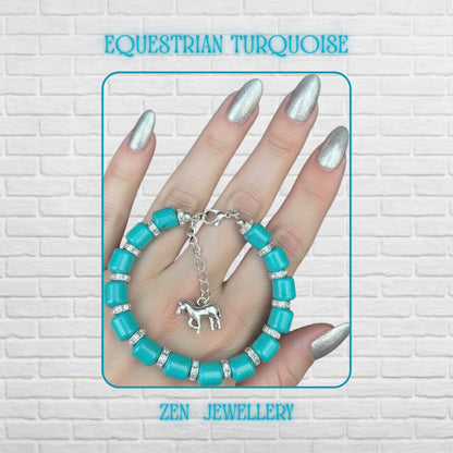Handmade turquoise beads bracelet displayed on a hand with metallic silver nails, featuring chunky barrel-shaped turquoise beads separated by sparkling rhinestone spacers and finished with a silver extension chain and detailed horse charm for a bold western boho look.