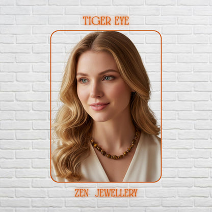 Elegant TIGER EYE necklace and bracelet set featuring polished brown, honey, and caramel gemstone beads with shiny gold spacer beads, delicate gold chain links, and secure gold clasps. The smooth tiger eye stones reflect warm natural light beautifully, creating rich earthy tones and luxurious texture. Styled on a soft marble surface with dried flowers, this handmade boho jewellery set feels warm, elegant, feminine, and perfect for everyday wear o