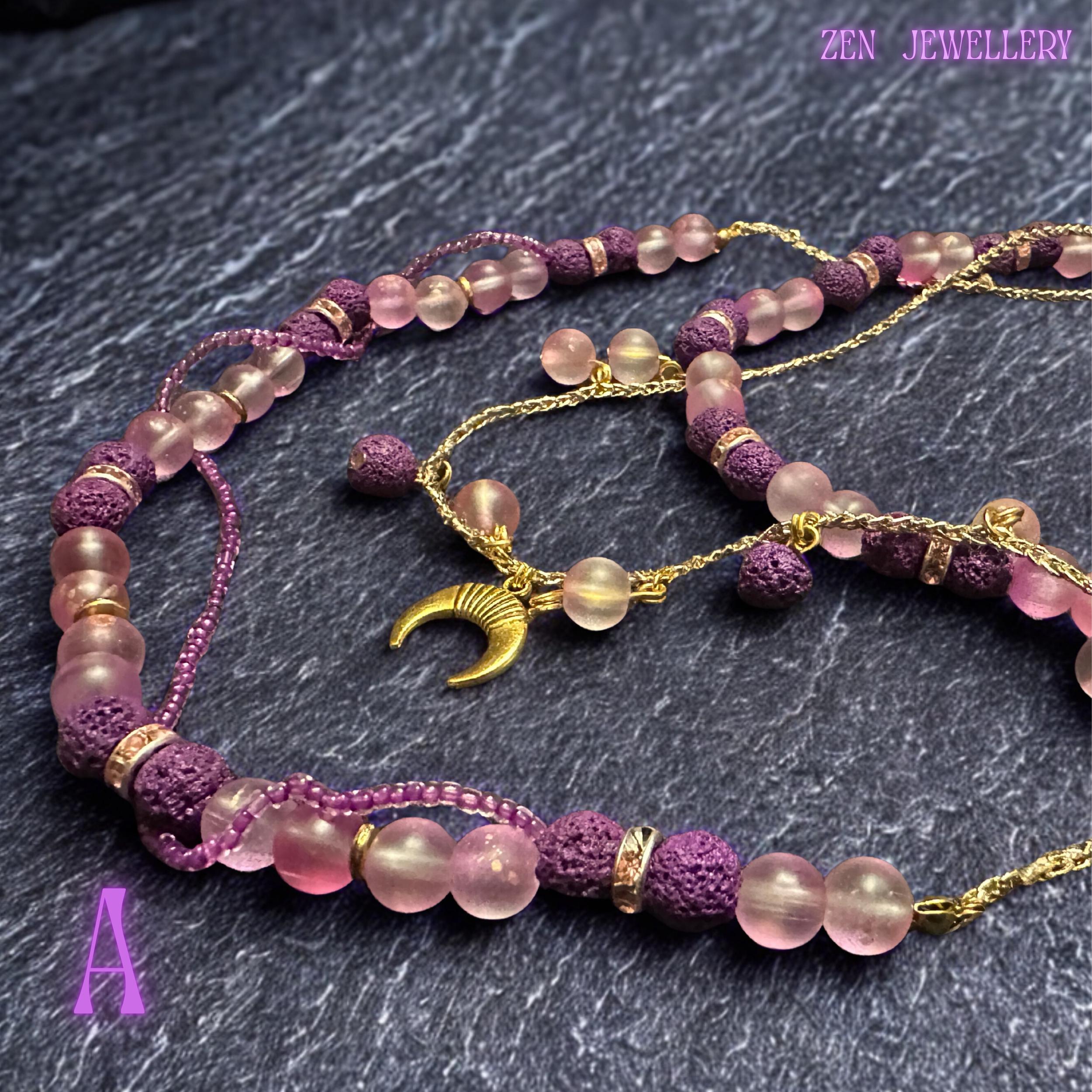• Detailed image of the upper necklace strand featuring alternating blush pink round gemstone beads and textured purple lava stone beads arranged symmetrically along a fine gold wire structure. Sparkling crystal spacer rings catch the light gently while the soft pastel colour palette creates a feminine romantic aesthetic inspired by celestial bohemian fashion and handcrafted gemstone jewellery collections.