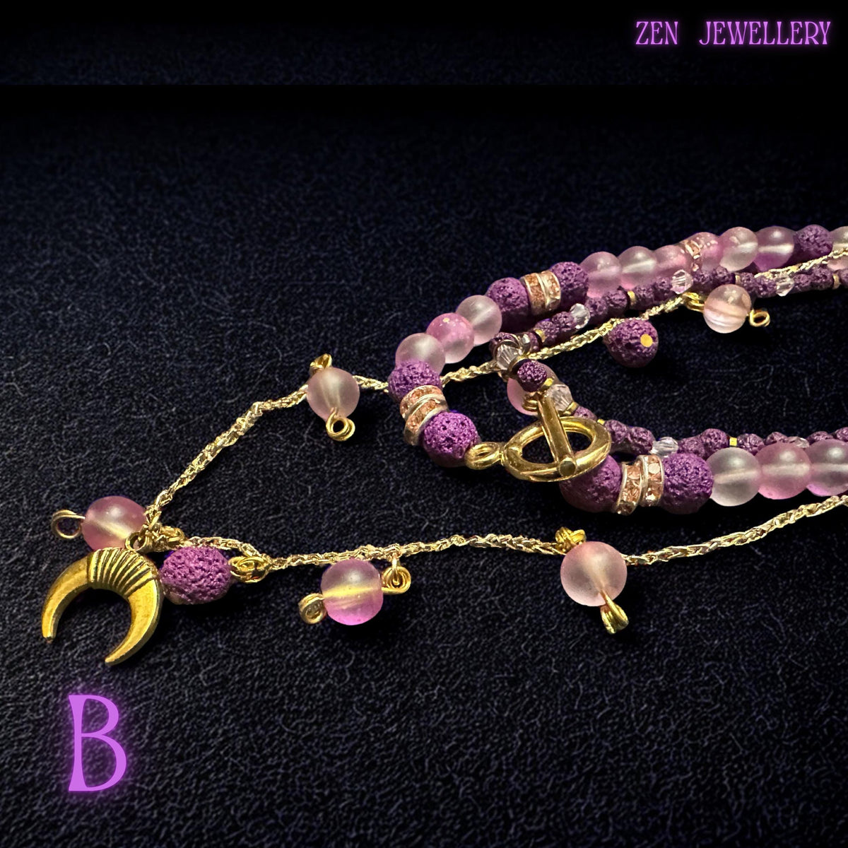 • Close-up view of the handcrafted bead arrangement highlighting the careful spacing between blush gemstone beads, purple lava stones, and rhinestone spacers. Tiny woven pink seed beads add intricate texture to the lower strand while the polished gold chain details bring softness and luxury. The artistic layered structure gives the jewellery depth and feminine movement suitable for statement styling.