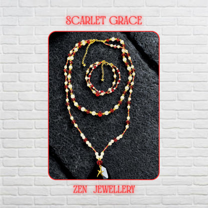 Close-up view of the layered red crystal necklace showing faceted ruby beads with glossy reflective surfaces positioned beside smooth round pearl white gemstone beads and tiny red seed bead details woven between the strands. The gold spacer beads add warmth and luxury, while the handcrafted arrangement creates texture, depth and elegant layered movement across the neckline. The jewellery feels feminine, lightweight and artistic.