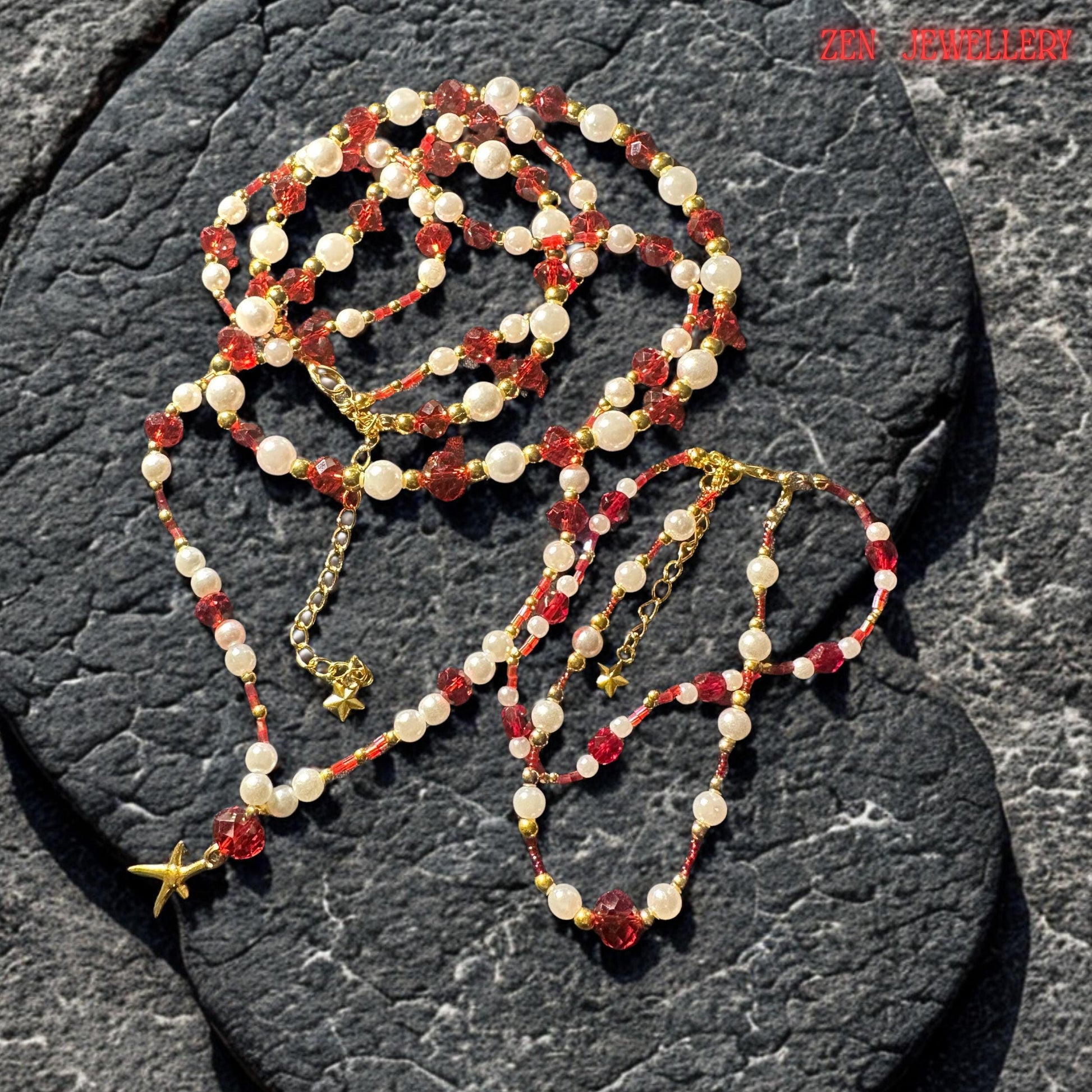 Ruby red faceted crystal beads sparkle intensely under soft lighting revealing rich wine red tones warm reflections and luxurious glass-like shine. The smooth pearl white gemstone beads balance the bold crystals with softness and elegance while the tiny gold accents create refined shimmer throughout the handcrafted layered jewellery design.