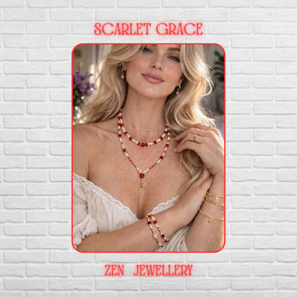 Elegant handmade layered necklace and bracelet jewellery set displayed on a dark textured stone background featuring sparkling ruby red faceted crystal beads paired with soft pearl white gemstone beads and delicate gold spacer accents. The layered necklace design creates graceful movement while the gold starfish pendant hanging from the centre strand adds a romantic coastal detail. The rich red crystals reflect warm light beautifully and contrast