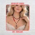 A sophisticated handmade black crystal necklace, displayed on a model, features glossy faceted black beads arranged in elegant, layered strands with red coral accents and a delicate gold moon pendant. The necklace combines bold geometric black stones with shimmering black crystal beads and small red details for dramatic contrast. The layered design creates a stylish statement jewellery look suitable for evening wear or modern bohemian fashion sty