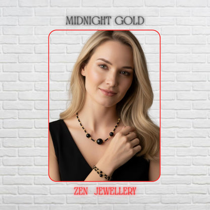 A sophisticated black agate jewellery set is displayed on a model featuring a matching necklace and bracelet crafted with glossy black gemstone beads and gold-tone decorative accents. The design combines delicate floral spacers and heart-shaped details with larger focal black agate beads, creating a balanced and elegant appearance. The neutral stone setting highlights the luxurious contrast between the rich black stones and warm gold elements whi