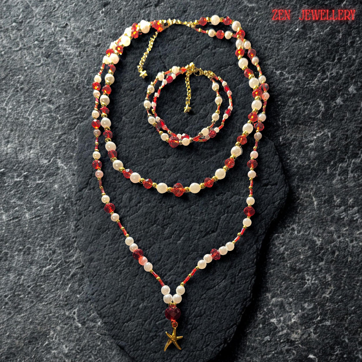 Matching handmade bracelet displayed above the necklace featuring alternating ruby red crystal beads and pearl white gemstone beads finished with a delicate gold adjustment chain and tiny star charm. The bracelet mirrors the layered necklace design beautifully creating a coordinated jewellery set full of sparkle texture and warm luxurious bohemian elegance perfect for gifting or occasion styling.