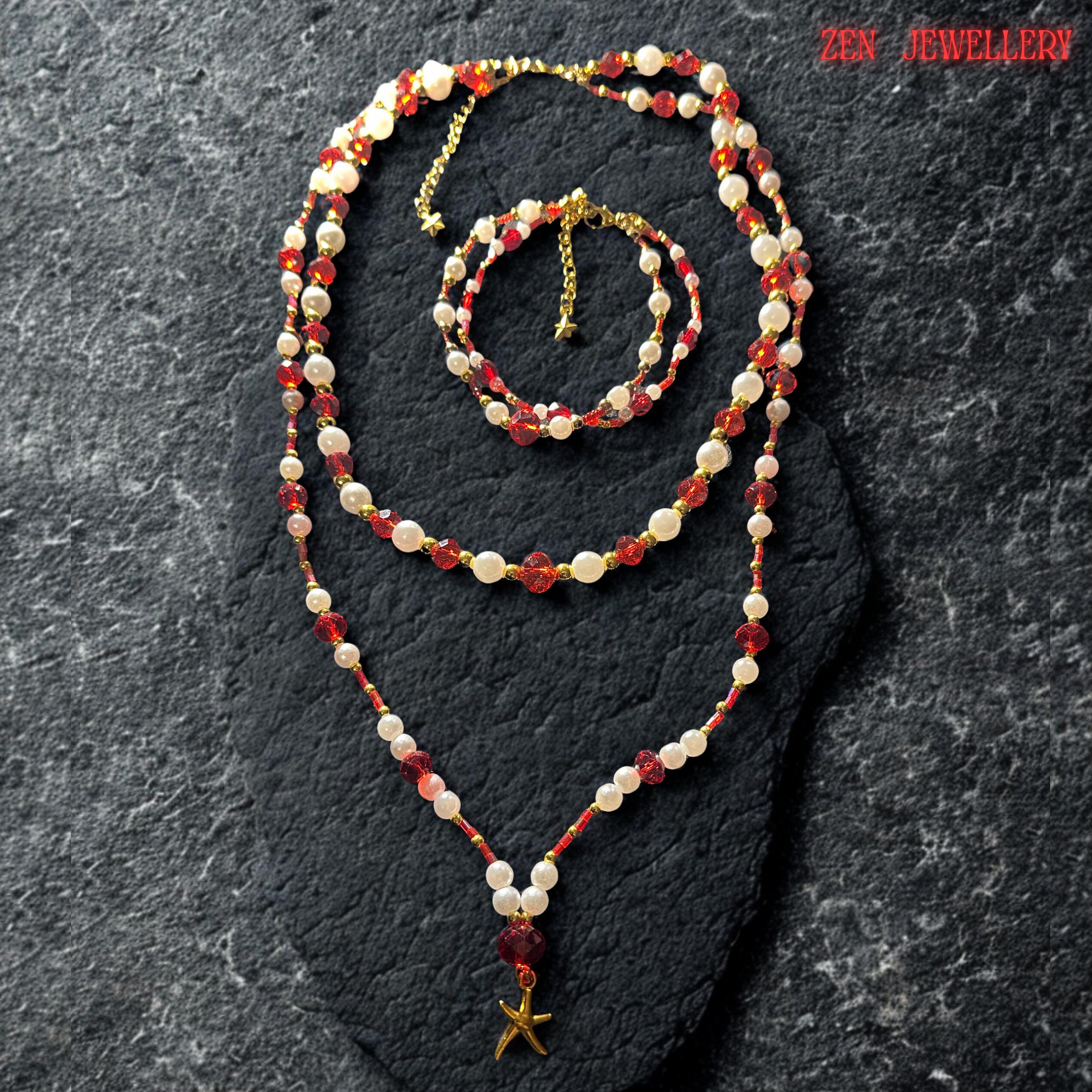 Matching handmade bracelet displayed above the necklace featuring alternating ruby red crystal beads and pearl white gemstone beads finished with a delicate gold adjustment chain and tiny star charm. The bracelet mirrors the layered necklace design beautifully creating a coordinated jewellery set full of sparkle texture and warm luxurious bohemian elegance perfect for gifting or occasion styling.
