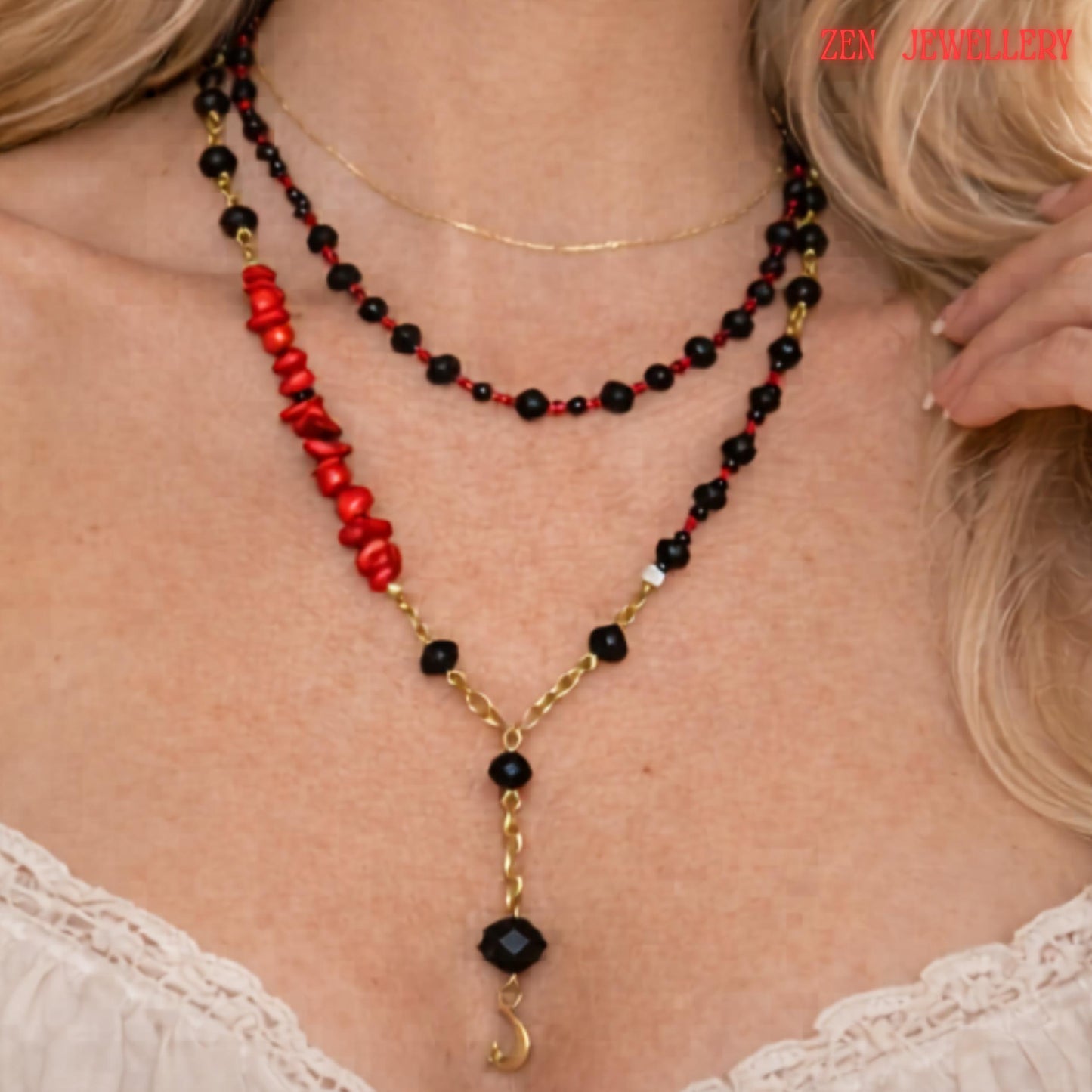 Detailed image highlighting the gold moon pendant suspended from a faceted black crystal bead at the centre of the layered necklace. The surrounding glossy black crystal beads and small red gemstone details create a luxurious monochrome look with subtle bold colour accents. The necklace combines celestial symbolism with modern geometric jewellery design.