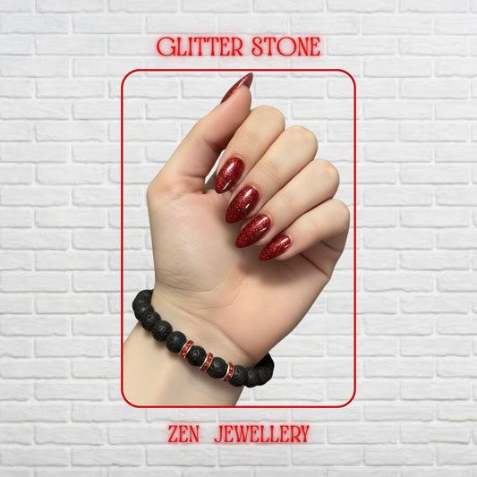 Handmade black lava stone bracelet with bright red rhinestone spacer accents creating elegant contrast. The bracelet features porous volcanic beads with matte texture and mixed bead sizes for a natural handmade appearance. The red crystal spacers add subtle sparkle and vibrant colour against the dark lava stones. Bracelet size is approximately 17 cm with comfortable stretch fit for everyday wear.