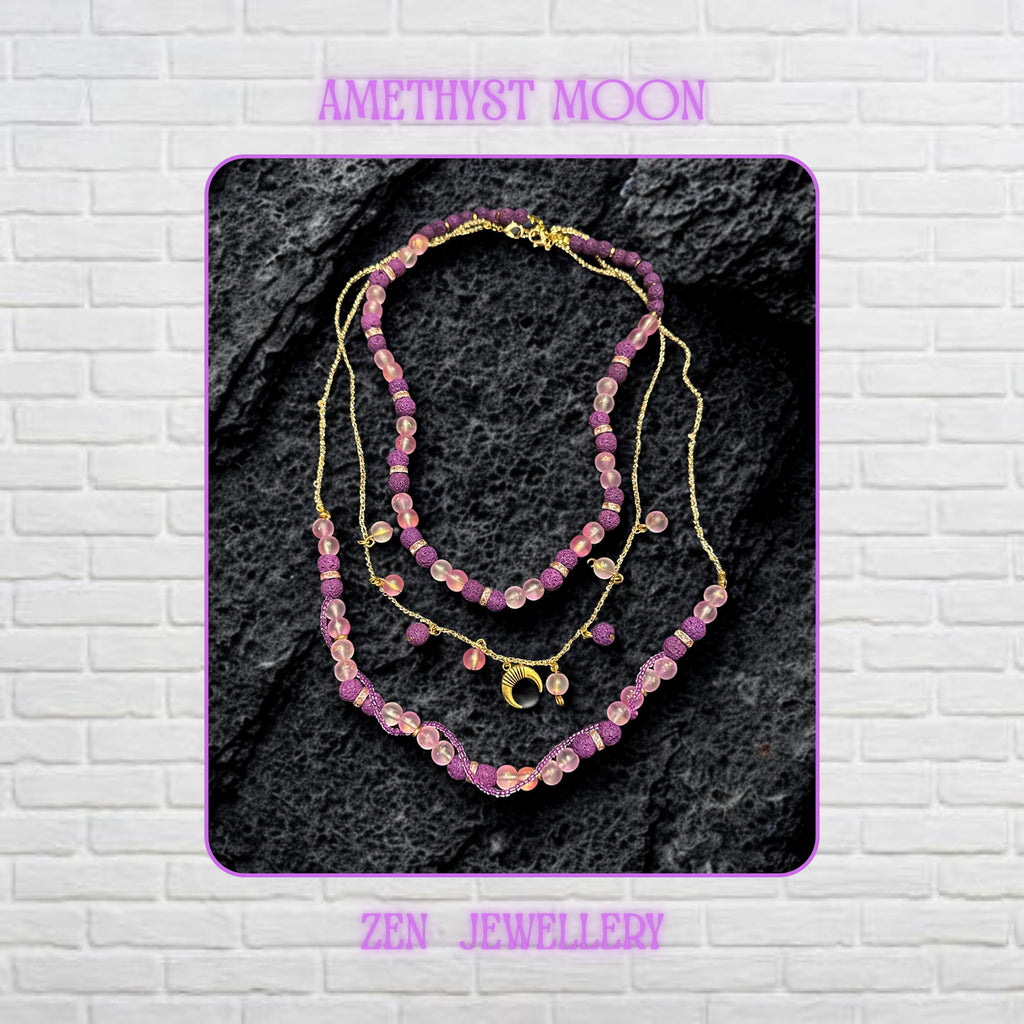 • Close-up view of the layered necklace showing polished translucent pink gemstone beads with a soft frosted glow contrasted against textured volcanic purple lava stone beads. Gold spacer rings with rhinestone sparkle separate the beads beautifully while the delicate gold chain drapes naturally across the dark decorative surface. The crescent moon charm becomes the focal point and adds mystical celestial elegance to the handmade artistic jeweller