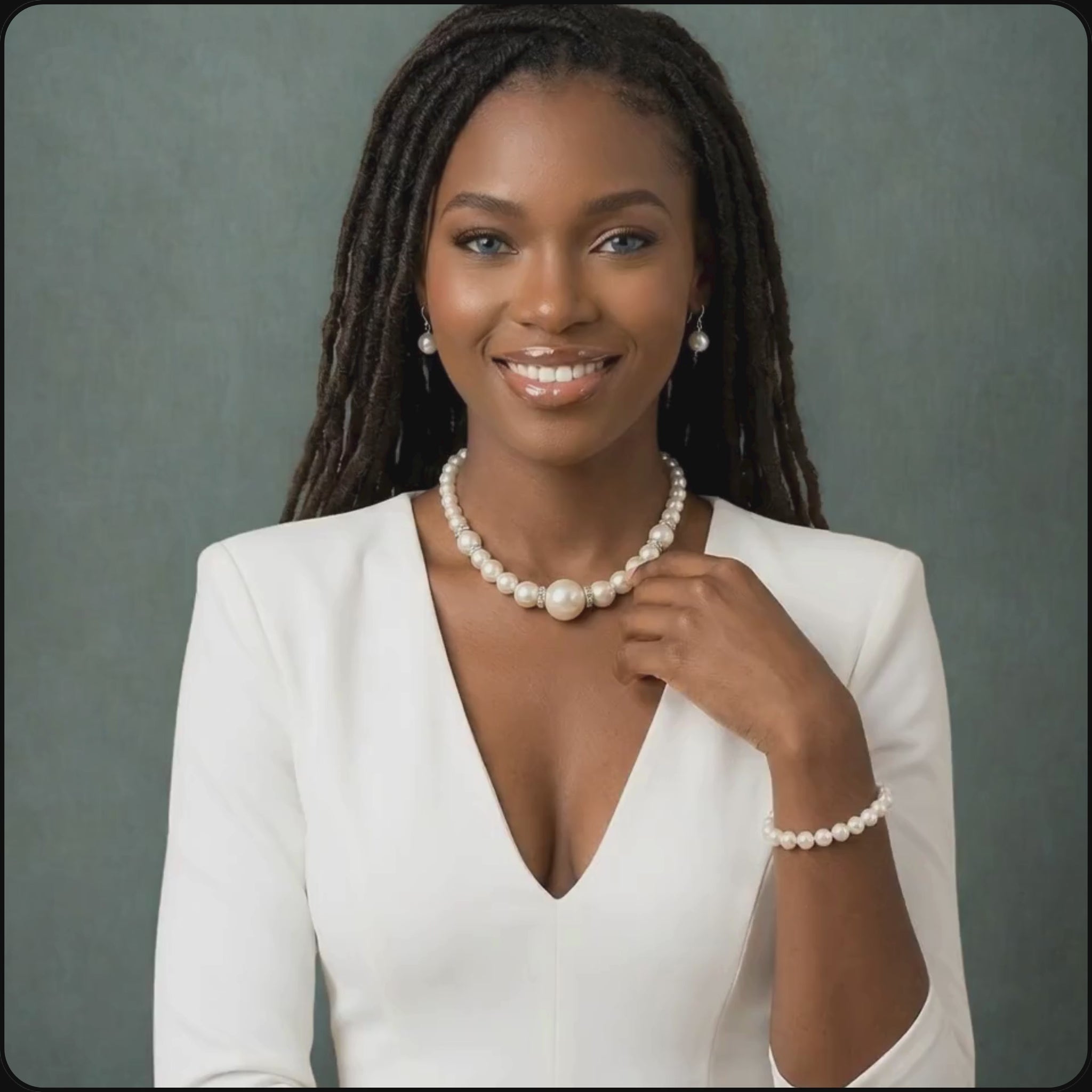 African model wearing a white pearls with silver rhinestones necklace and bracelet set