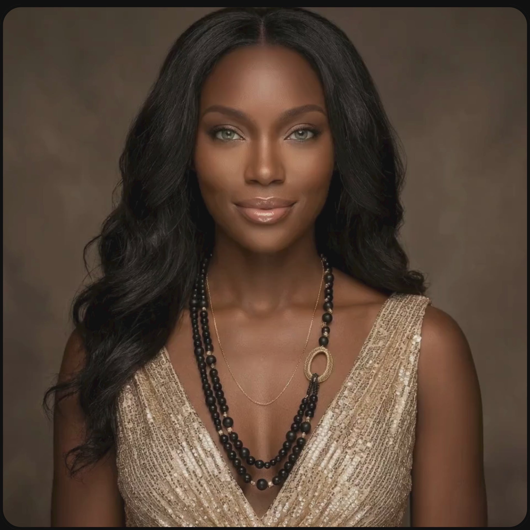 African model wearing golden and black onyx necklace