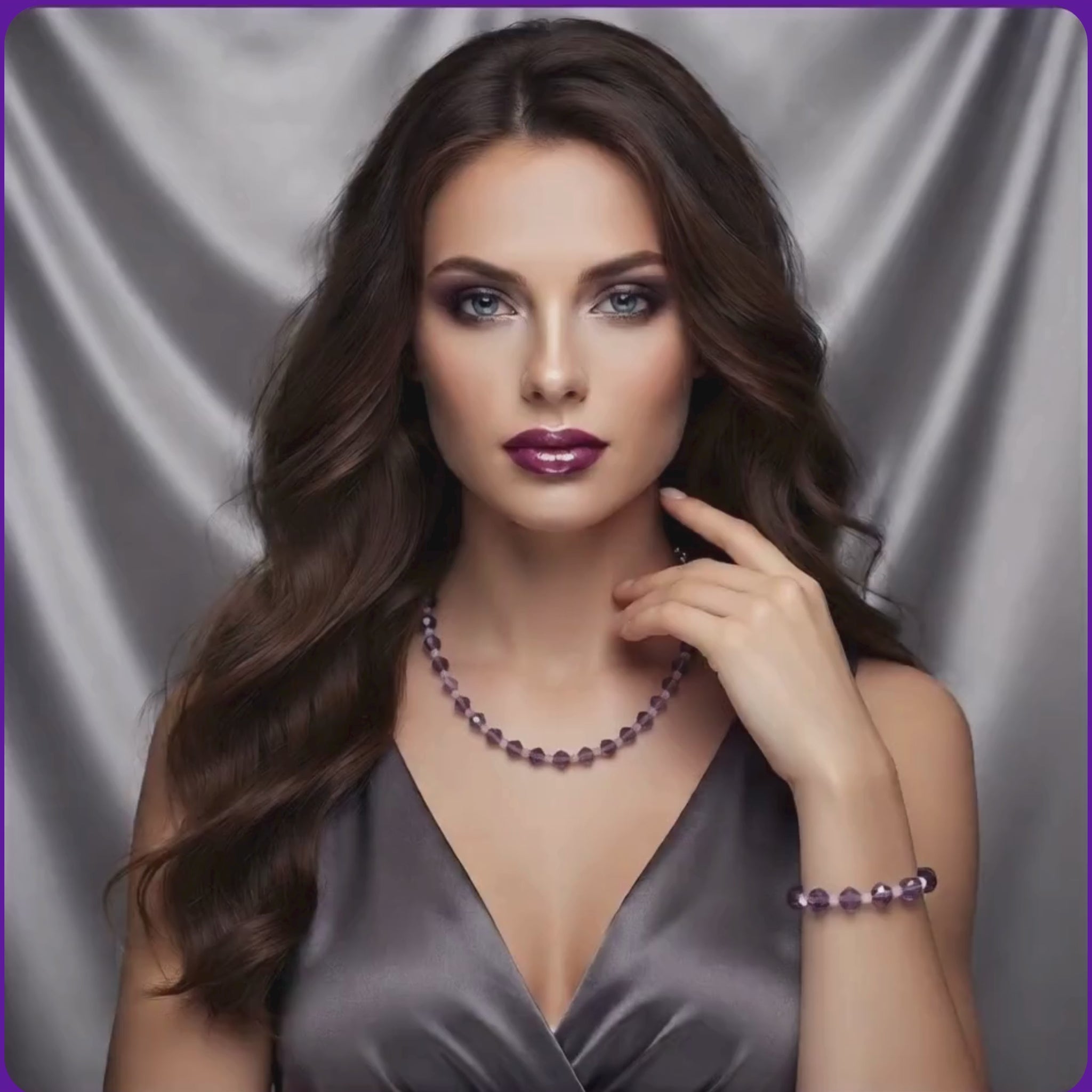 A video shows a model with purple crystal and pearl necklace and bracelet set, wearig a beautiful grey satin dress.